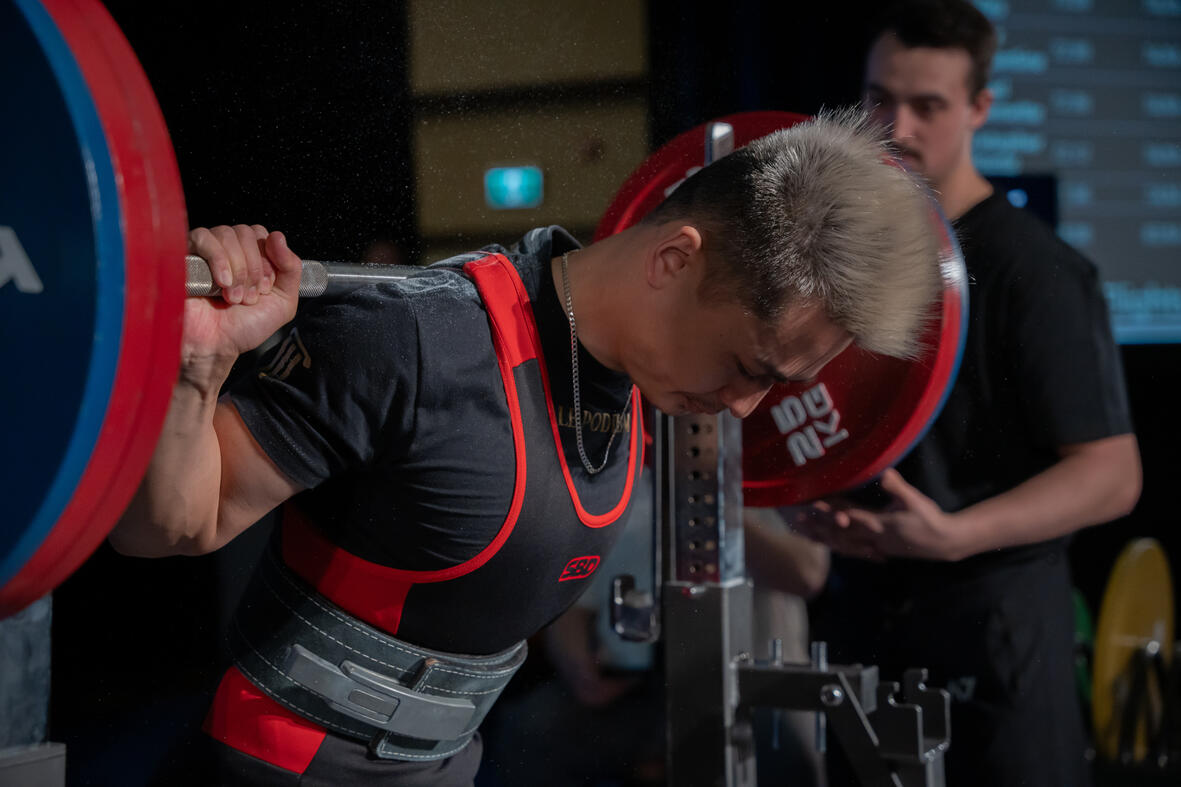 Coach Daniel demonstrating proper form during a fitness training session